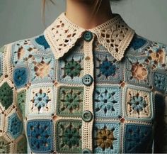 a woman wearing a crocheted jacket with flowers on it