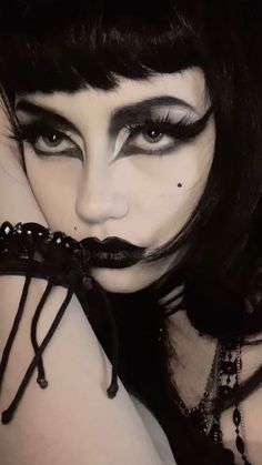 Impress any goth girl with our curated list of the top goth gifts for her. Explore unique and darkly enchanting gift ideas in our guide! 80s Gothic Makeup, Trad Goth Makeup Dark Skin, Trad Makeup Goth, Goth Rock Makeup, Goth Makeup Thick Eyebrows, Witchy Goth Makeup, Goth 80s Makeup, Beginner Trad Goth Makeup