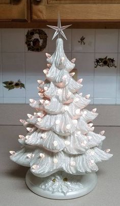 a white ceramic christmas tree sitting on top of a counter