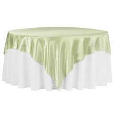 a round table covered with a light green and white satin tablecloth on an isolated background