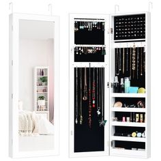 a white closet with jewelry hanging from it's doors