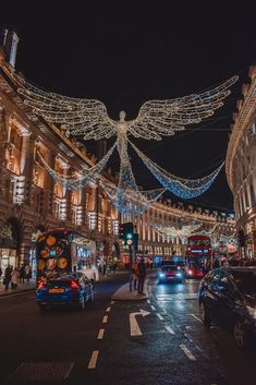 a busy city street at night with christmas lights