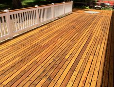 a wooden deck with white rails and railings