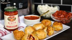 some food is sitting on a white plate and next to a crock pot with sauce