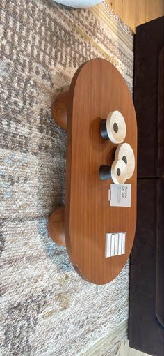 two rolls of toilet paper sitting on top of a wooden table next to a mirror