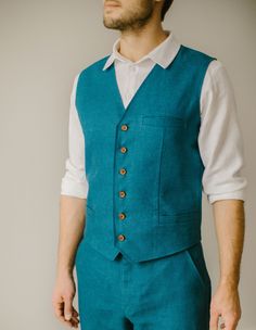 "Our rustic wedding waistcoat stands as an example of our commitment to quality. Each one is handmade, with an exclusive focus on tailoring to the unique measurements of our customers. We firmly prioritize craftsmanship over mass production, ensuring that every creative and sewing task is duly recognized and rewarded. DESCRIPTION. Our rustic wedding waistcoat has buttons in the front, three pockets, and a double layer in the front. This vest blends modern and timeless styles, so it's a great add Fitted Vest With Buttons For Wedding, Fitted Wedding Vest With Buttons, Tailored Sleeveless Three-piece Suit For Wedding, Sleeveless Vest With Buttons For Wedding, Fitted Nehru Jacket For Groom, Classic Fitted Nehru Jacket For Groom, Fitted Sleeveless Nehru Jacket For Wedding, Fitted Wedding Vest, Linen Vest Mens