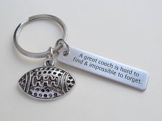 a silver keychain with a football charm on it that says, a great coach is hard to find and impossible to forget