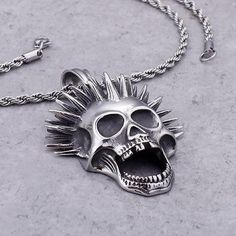 Even the dead have their dose of madness. This punk necklace with an eccentric cut is perfect for those who aren't afraid of other people's gaze! This punk skull necklace is a must for punk people, for people fond of Blink-185 or even Sum 41. As you may have noticed, it is totally painted in silver, making this necklace a unique and really attractive jewel for punk people and their black outfits. Also, as you can see, it has a foxtail bead attached to a screaming skeleton head with punk liberty Edgy Halloween Streetwear Necklaces, Edgy Halloween Streetwear Necklace, Emo Streetwear Jewelry For Halloween, Punk Metal Necklace With Skull Print, Punk Style Metal Necklace With Skull Print, Punk Skull Jewelry For Halloween, Punk Style Skull Jewelry For Halloween, Punk Style Jewelry For Halloween Concert, Punk Necklaces For Halloween Concert