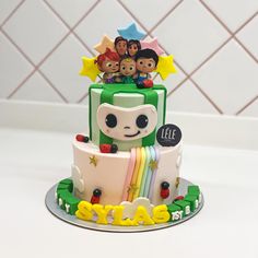 a birthday cake decorated with toy figures on top