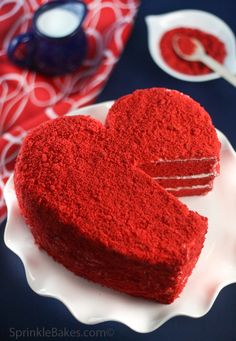 a heart shaped red velvet cake on a plate