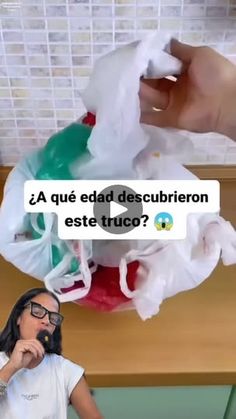 a woman sitting in front of a pile of plastic bags on top of a table