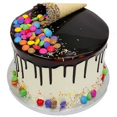 an ice cream cake decorated with candy and sprinkles