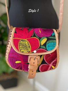 Embroidered Genuine Leather Bag Dare to be bold and adventurous with our Handcrafted Leather Purse, carefully crafted in Chiapas Mexico by our skilled partners. Made with genuine leather and adorned with exquisite embroidery, this purse exudes elegance and sophistication. The 7"x8" dimensions provide ample space for your essentials, while the 8 inch strap allows for easy and comfortable wear. Elevate your look and add a touch of Mexican flair to your outfit with this unique and striking accessor Leather Bag With Floral Embroidery And Rectangular Shape, Leather Shoulder Bag With Floral Embroidery, Rectangular Leather Bag With Floral Embroidery, Floral Embroidered Shoulder Bag For Travel, Leather Shoulder Bag With Floral Embroidery For Daily Use, Embroidered Satchel Shoulder Bag, Floral Embroidered Crossbody Travel Bag, Embroidered Crossbody Shoulder Bag For Travel, Embroidered Crossbody Satchel For Daily Use