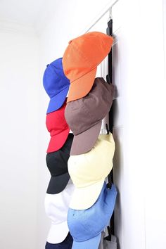 several hats are hanging up on the wall