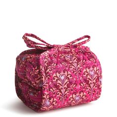 This compact cosmetic case features three zip compartments and a secure zip TPU pocket, perfect for storing your beauty essentials with ease. The elegant tie closure adds a touch of sophistication to your daily routine, making it a stylish addition to your beauty collection. Vera Bradley Wicked All Wrapped Up Cosmetic Bag in Bewitching Pink