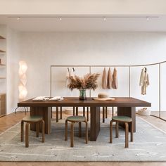 a dining room table with chairs and an area rug