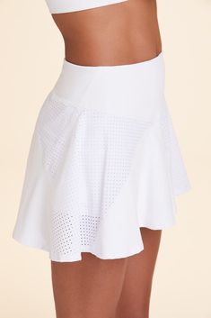 Marry country club style with high-performance design and you've got this stunning and versatile country club skirt. The built-in brief features a stash pocket on each thigh for both your phone and tennis ball, all while making sure you're able to run around the court in comfort. 13.75" in length Tennis skort with pockets and attached brief Pindot mesh inserts for ventilation Fabric provides SPF50+ protection. Flatlock seaming Stash pocket on each leg Club Skirt, Country Club Style, Club Skirts, Tennis Fashion, Tennis Skort, Club Style, Crop Top Sweater, Tennis Ball, Tennis Skirt