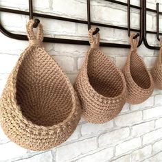 three baskets hanging on a brick wall