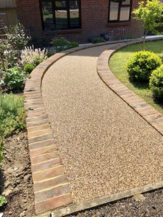 a brick walkway in front of a house