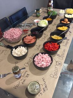 a table topped with bowls filled with different types of salads and condiments