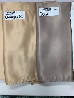 three different colors of satin material with labels on the front and back of each one