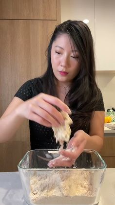 a woman is mixing ingredients in a bowl