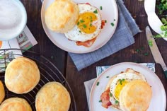 three plates with breakfast foods on them sitting on a table