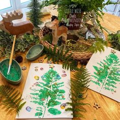 the table is covered with plants and other items to make christmas cards for someone's family