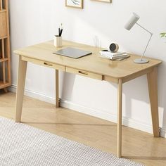 a wooden desk with a laptop on it