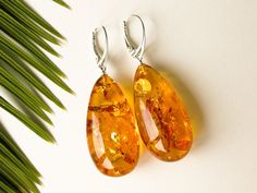 "Massive natural Baltic amber cognac color earrings is a perfect choice for classy style admirers! Perfect choice to brighten up office outfit or look even more beautiful on a special occasion! Shaped in drop form these earrings are the best example of royal and unforgettable jewelry. MATERIALS AND SIZE: Stone: 100% Natural Baltic Amber Findings: sterling silver 925 Weight: 11,3 g (0,39 oz) Bead size: 3,7 cm (1,45 in) x 1,9 cm (0,74 in) Total earring lenght: 5,7 cm (2,24 in) PLEASE NOTE: All our Elegant Baltic Amber Jewelry In Orange, Elegant Orange Baltic Amber Jewelry, Baltic Amber Earrings As A Gift, Amber Earrings For Gift, Elegant Handmade Amber Earrings, Elegant Yellow Baltic Amber Earrings, Elegant Amber Teardrop Earrings, Handmade Elegant Baltic Amber Earrings, Elegant Amber Earrings For Formal Occasions