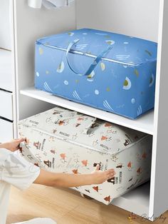 a woman is reaching for a suitcase on the shelf