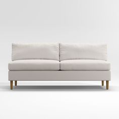 a white couch sitting on top of a wooden floor