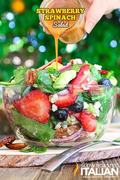 a salad with strawberries, blueberries, pecans and other fruits in it