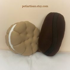 two brown and white pillows sitting next to each other