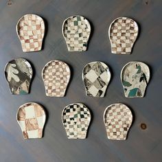 nine pieces of pottery sitting on top of a wooden table next to each other in different shapes and sizes