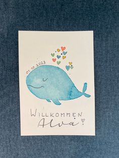 a blue whale with hearts on it's back and the words willkommen always written in black ink