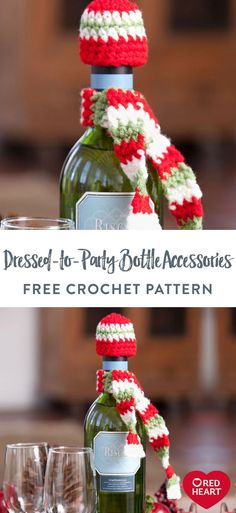 a bottle and two glasses sitting on top of a table with red, white and green crocheted decorations