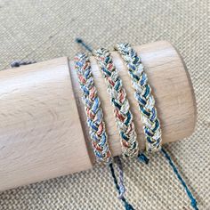 This listing is for one metallic cord braided bracelet.  Choose from one of three color ways- 1.  Green/tan/copper with gold metallic cord 2.  Gray/blue/copper with gold metallic cord 3.  Green/navy/white with gold metallic cord Have an idea for a custom listing?  Send me a convo, I reply quickly.   Perfect for stocking stuffers!   Each bracelet will fit all wrist sizes and is 100% waterproof.  Last picture is showing how I style them with other bracelets. All bracelets are made and ready to shi Adjustable Braided Waxed Cord Bracelets, Adjustable Waxed Cord Braided Bracelet, Multicolor Adjustable Braided Waxed Cord Bracelet, Multicolor Braided Bracelet With Adjustable Waxed Cord, Multicolor Adjustable Braided Bracelet, Friendship Braided Bracelet With Adjustable Nylon Cord, Friendship Braided Bracelet In Nylon Cord, Bohemian Braided Bracelets With Adjustable Length, Friendship Adjustable Braided Waxed Cord Bracelets