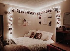 a bedroom with lights and pictures on the wall