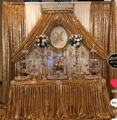 a table with gold sequins and white flowers on it is set up for a wedding reception