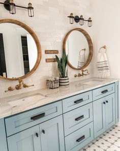 a bathroom with two sinks and mirrors on the wall