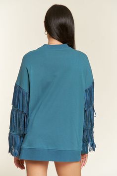 Expertly crafted with a suede silver studded fringe trim at the sleeve, this oversized top boasts ribbed hems and exposed seaming for a unique and stylish look. The dropped shoulder and long sleeve design adds comfort and versatility. Made from a blend of 85% cotton and 15% polyester, this top is both soft and durable. Elevate your wardrobe with this statement piece. -Suede silver studded fringe trim at sleeve-Oversized fit-Ribbed hems-Exposed seaming-Pullover-Dropped shoulder with long sleeve-8