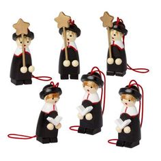 a set of four black and white figurines with red string attached to them