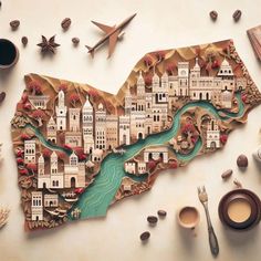 a wooden cut out of the shape of a map with coffee cups and spoons