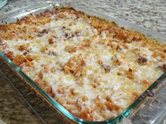 a casserole dish with meat and cheese in it sitting on a counter top