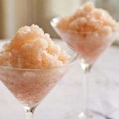 two martini glasses filled with sugar on top of a table