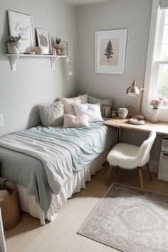 a small bedroom with a bed, desk and chair in the corner next to a window