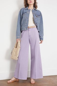 The Forte Forte Old Peach Gabardine Wide Leg Pants in Lavender exudes urban edge and contemporary cool. These wide–leg trousers are bound to astound with their feminine allure and the delicately romantic texture of the fabric. The faded effect of the brushed cotton gabardine and the candy colour palette temper this garment's formal restraint and set a languid mood. FIT DESCRIPTION This garment fits true to size, take your normal size. High-rise, wide leg, cut for a comfort fit Pants made in iIal Lavender Pants Outfit Winter, Pastel Colored Outfits Women, Lilac Wide Leg Pants Outfit, How To Style Lavender Pants, Lavander Outfits Casual, Purple Wide Leg Pants Outfit, Lavender Trousers Outfit, Lavender Pants Outfit Work, Lavender Pants Outfit