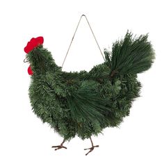 a chicken made out of pine branches and red flowers hanging from it's back