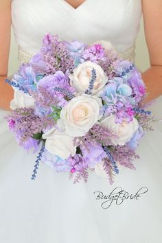 a bride holding a purple and white bouquet